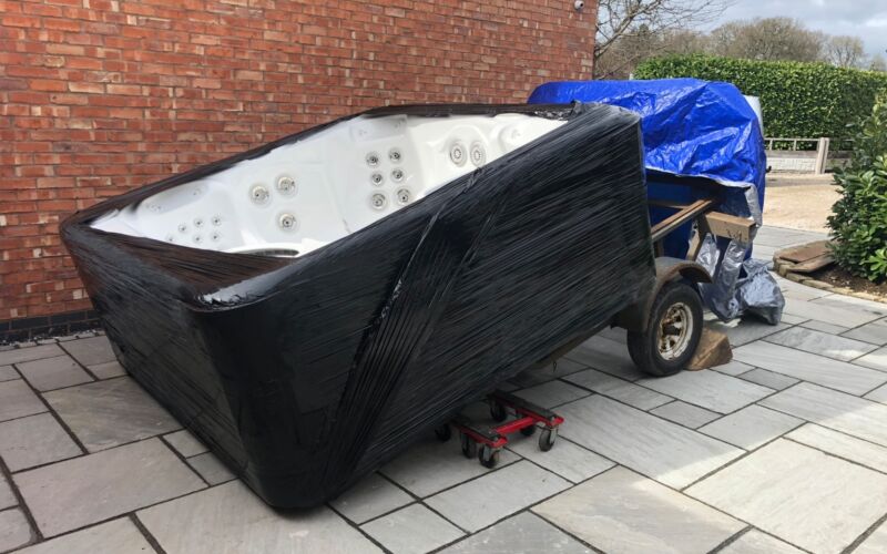 Tub on hot tub dolly being delivered