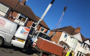 Hot tub being delivered and lifted by crane