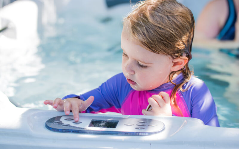 Little girl playing with topside controls